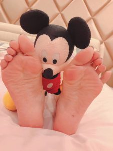 asian girl bare feet mickey toy toes press